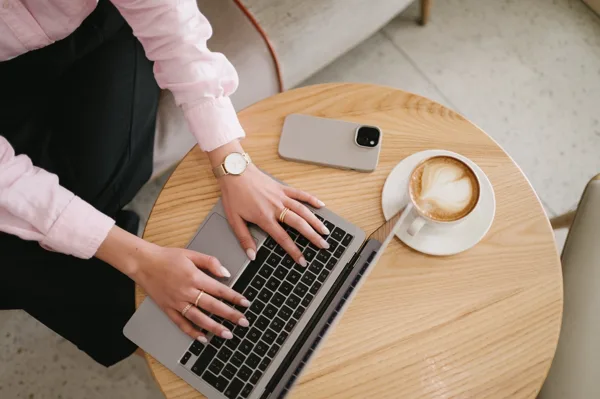 Working on a laptop with a coffee